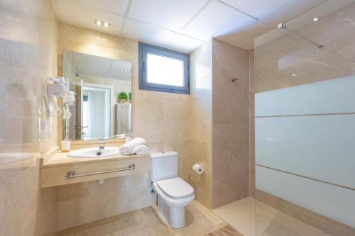a bathroom with a toilet and a sink and a shower at Cala alta in Benidorm