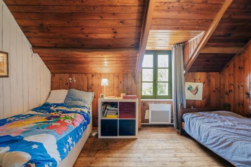a bedroom with two beds in a wooden house at Maison Pleneuf Val André Plage 5min in Pléneuf-Val-André