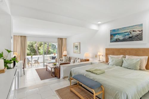 a bedroom with a large bed and a living room at Miraflores A112 in La Cala de Mijas