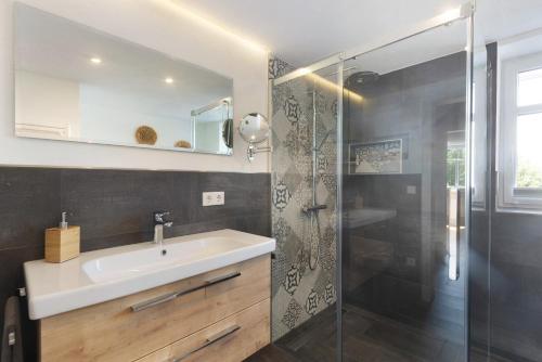 a bathroom with a sink and a shower at Fewo Feldmann Auf Der Mauer in Schmallenberg