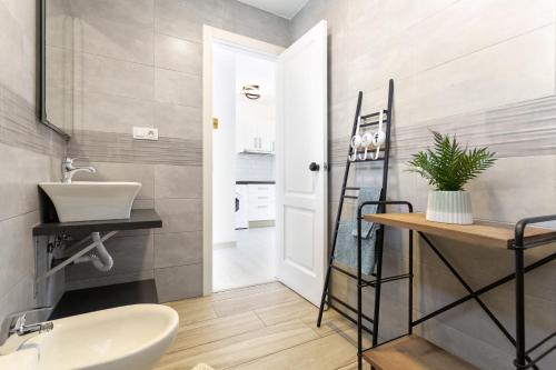 a bathroom with a sink and a toilet in it at Relax Holidays Corralejo in Corralejo