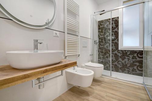 a bathroom with a sink and a toilet and a mirror at Moneglia Monte in Moneglia