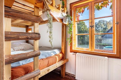 a bedroom with two bunk beds and a window at Casa del Sol - Fachwerkhäuschen in Lychen