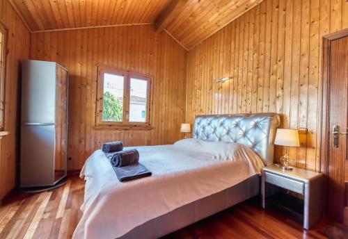 a bedroom with a bed and a refrigerator in a room at Costacabana - Villa Primadonna in Lloret de Mar