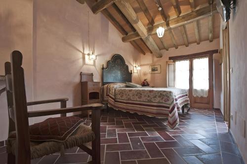 a bedroom with two beds and a chair in a room at All Inclusive Villa Con Piscina in Camaiore