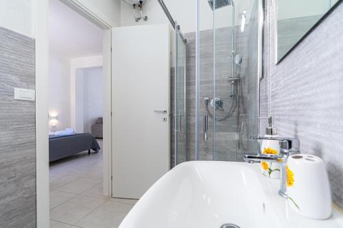 a bathroom with a shower and a white tub at L' oro dei Magi San Lorenzo in Reitani