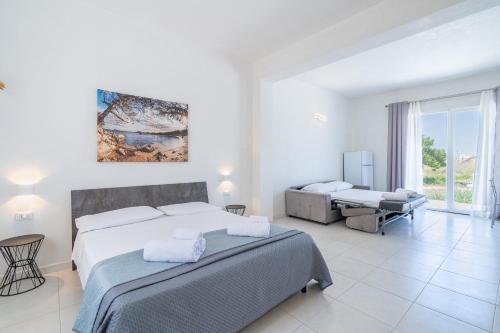a white bedroom with a bed and a desk at L' oro dei Magi San Lorenzo in Reitani