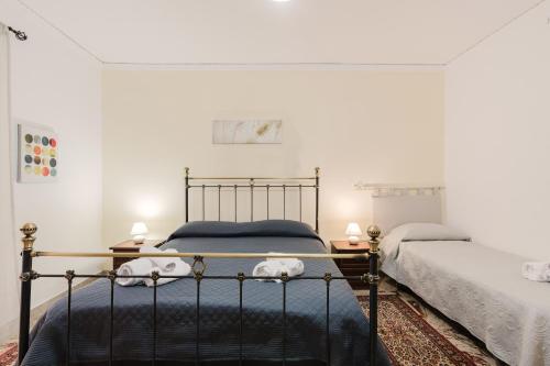 a bedroom with two beds and two lamps at Beneath The Castle - Apartment in Corleone