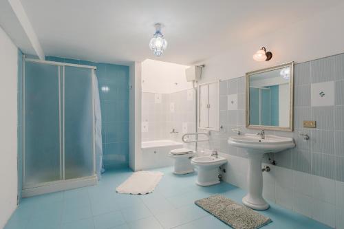 a bathroom with a sink and a toilet and a shower at Beneath The Castle - Apartment in Corleone