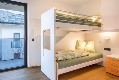 a bunk bed in a room with a window at Falsers Mountain Lodge in Cornedo all'Isarco