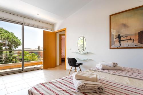 a bedroom with a bed and a large window at Exclusive Villa with pool seaview in Tossa de Mar