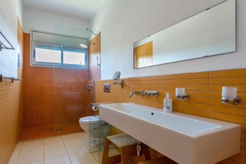 a bathroom with a sink and a shower and a toilet at Exclusive Villa with pool seaview in Tossa de Mar