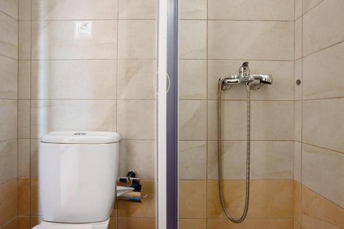 a bathroom with a shower with a toilet and a shower head at Zante View Family Studio 2 in Tsilivi