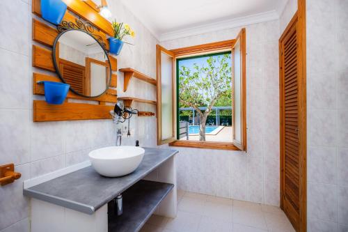 a bathroom with a sink and a mirror at Villa Can Neo in Santanyi