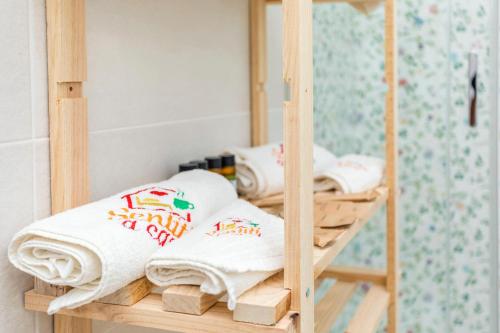 a wooden bunk bed with towels on it at Sentiti A Casa - Bronte in Bronte