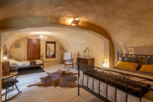 a bedroom with a bed and a room with a bed at La Voûte Des Oliviers in Bessas