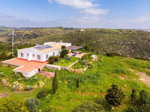 an aerial view of a house on a hill at Casa das Furnas - Eco Home in Vila do Bispo