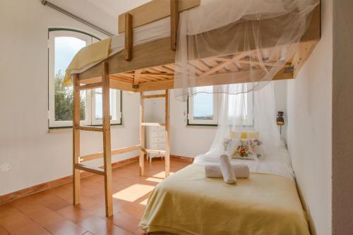 a bedroom with a bunk bed in a room at Casa das Furnas - Eco Home in Vila do Bispo