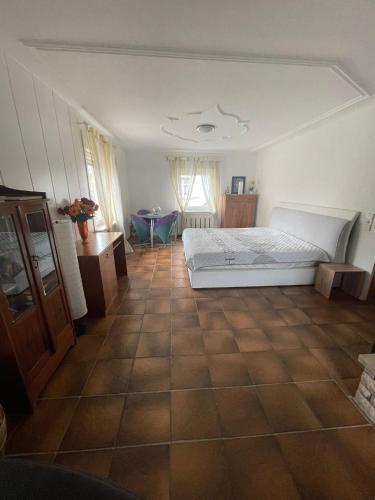 a bedroom with a bed and a tiled floor at Ferienwohnung Sprang in Steinen