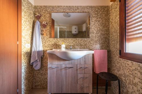 a bathroom with a white sink and a mirror at Casa di Stefania in Fluminimaggiore