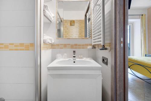 a bathroom with a white sink and a mirror at Ce Tour - Cetara Guest House in Cetara