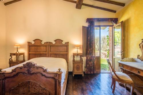 a bedroom with a bed and a dresser and a desk at Podere Montorgialino in Murlo