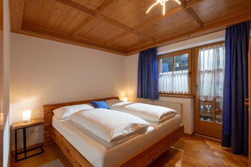 a bedroom with two beds and a window at Zeunerhof in Fügen