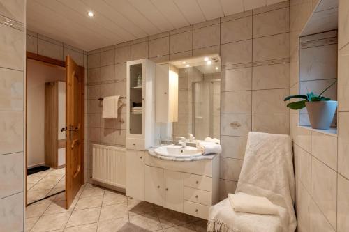 a bathroom with a sink and a mirror at Zeunerhof in Fügen