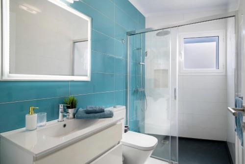 a bathroom with a toilet and a glass shower at Tritón 6 in La Santa