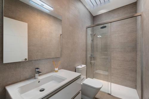 a bathroom with a sink and a shower and a toilet at Villa Violeta in Costa Del Silencio