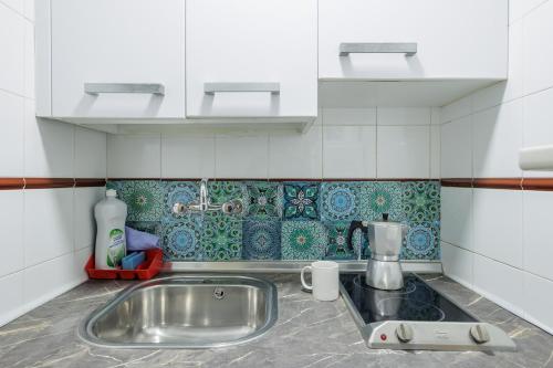 a kitchen with a sink and aaucet at Triana Historic Center in Seville
