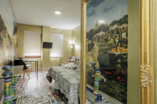 a room with a framed picture of a bedroom at Triana Historic Center in Seville