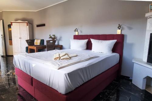 a bedroom with a large bed with a red headboard at Windjammer in Koserow