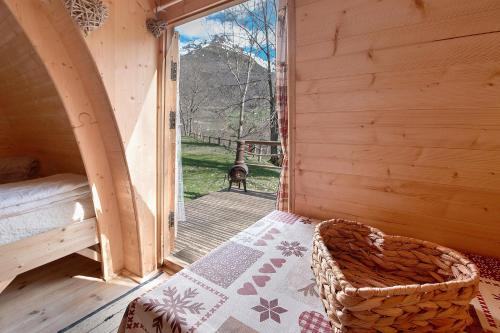 an open door to a room with a bed and a porch at Cabane Perce Neige - Gavarnie in Gèdre