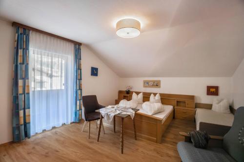 a living room with a table and a couch at Ferienwohnung Brugger 4 Personen in Kaltenbach