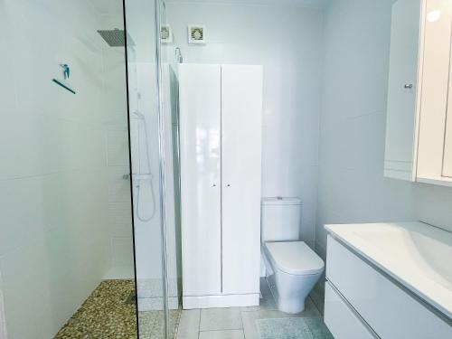 a white bathroom with a toilet and a shower at Front Americano in Torrox Costa