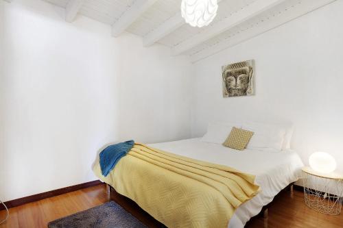 a bedroom with a bed with a yellow blanket on it at Sunset Cliffs By Slice Of Heaven in Ribeira Brava