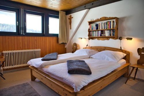 a bedroom with a wooden bed with two pillows on it at Ferienhaus Hochtal in Bernau im Schwarzwald