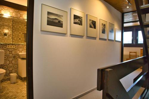 a hallway with a bathroom with pictures on the wall at Ferienhaus Hochtal in Bernau im Schwarzwald