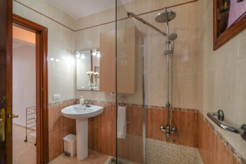 a bathroom with a sink and a glass shower at Bungalow Playa Bastián in Costa Teguise