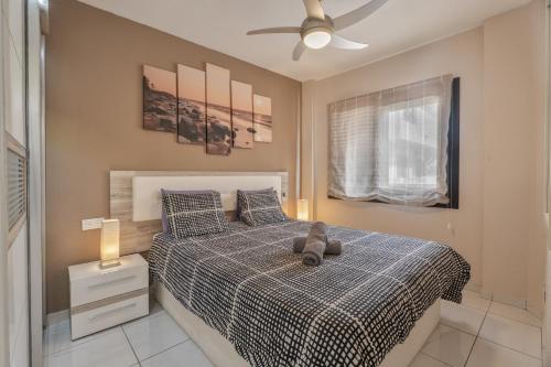 a bedroom with a bed with a teddy bear on it at Cathamarcella in San Miguel de Abona