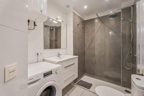 a white bathroom with a sink and a shower at Cathamarcella in San Miguel de Abona