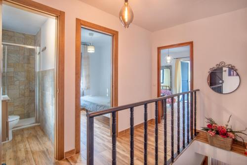a staircase with a glass door leading to a bathroom at Casa Rural Monte Dios in Jubrique