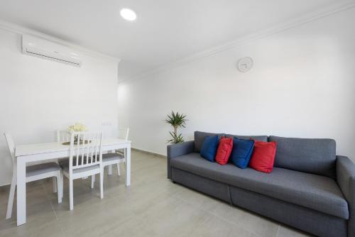 a living room with a couch and a table at Victoria's House in Sagres