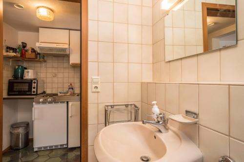 a bathroom with a sink and a mirror at Ferienwohnung Achraintal 4 in Lindau
