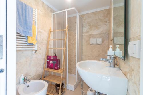 a bathroom with a white sink and a shower at Water Run in Bari