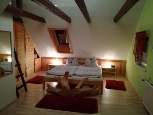 a bedroom with a bed and two rugs on the floor at Ferienwohnung Seilerberg in Freiberg