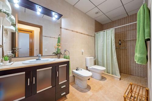 a bathroom with a sink and a toilet and a shower at Ca la Mercè in Camarles