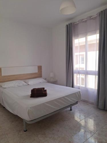 a bed with a bag on it in a bedroom at Casa Rosi in Gran Tarajal