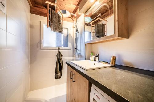 a tiny kitchen with a sink and a counter at Chalet 6p - Le casse noisette in Verchaix